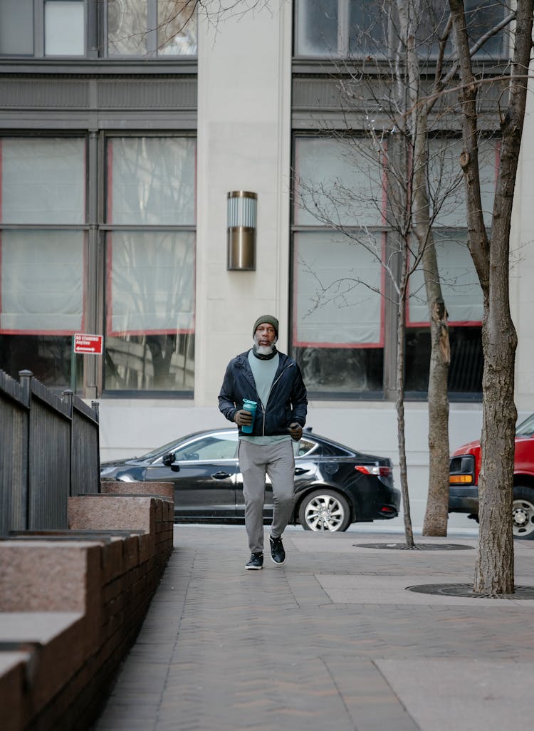 Trendy Senior Black Man Walking Along Sidewalk