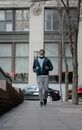 Trendy black man running on pavement near fence