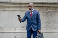 Man in Blue Suit Jacket Holding Black Smartphone