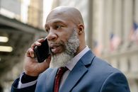 Man in Blue Suit Holding Black Smartphone
