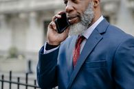 Man in Blue Suit Taking on the Cellphone