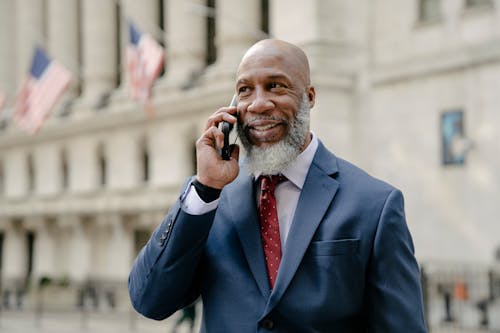 Free A Man in Blue Suit Jacket Holding a Phone Stock Photo