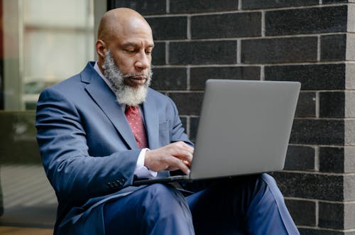 Free A Businessman Using a Laptop Stock Photo