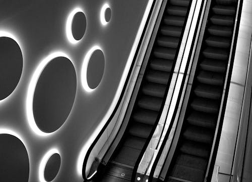 Grayscale Photo of an Escalator