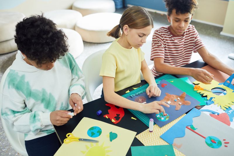 A group of children gathered around a table for a creative workshop
