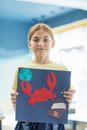 Woman Holding Blue and Red Heart Print Book