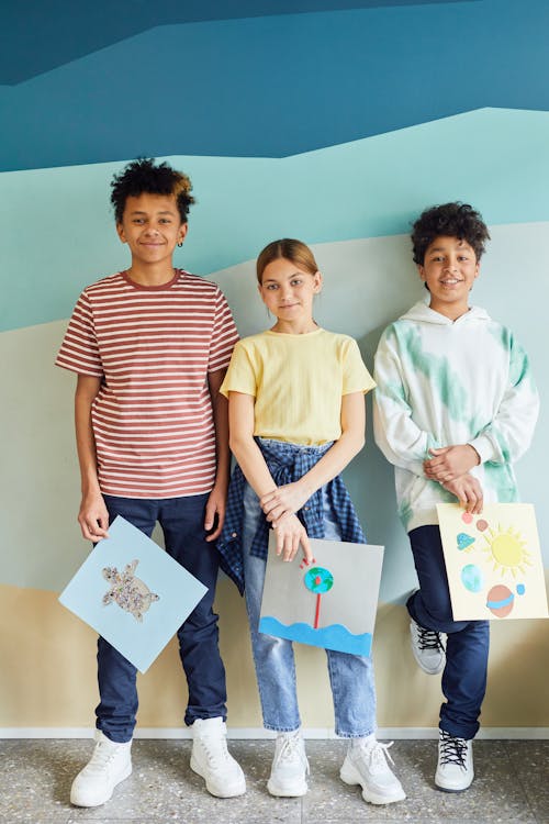 Free Young Students Holding their Art Projects Stock Photo