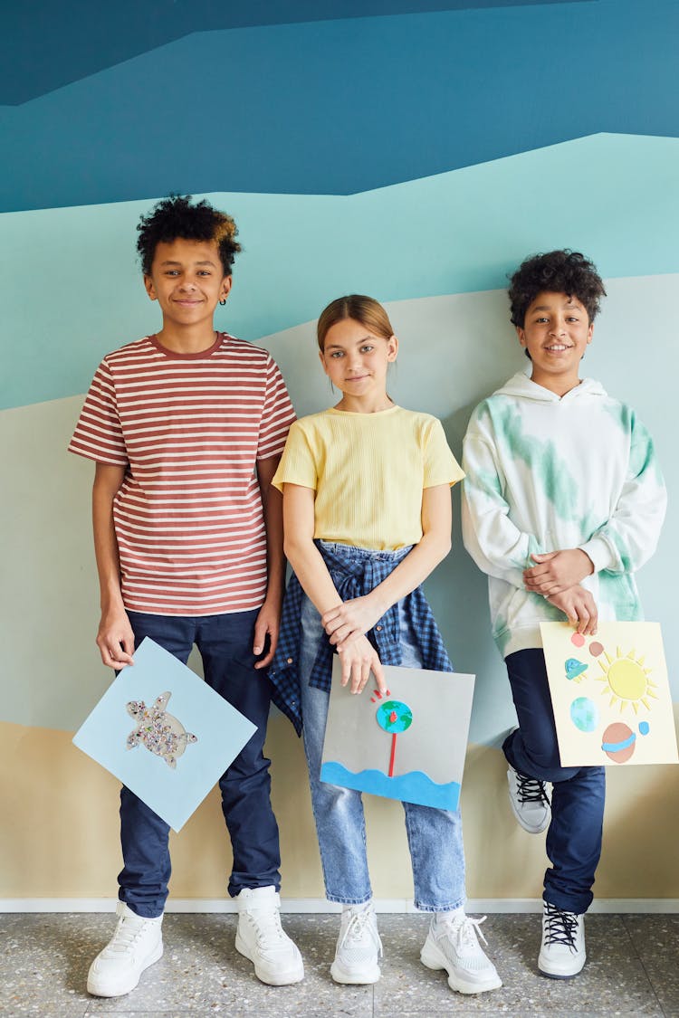 Young Students Holding Their Art Projects