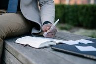 Person in Gray Long Sleeve Shirt Holding White Pen