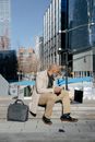 Man Sitting on a Bench Using a Laptop