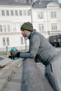 Man in Gray Jacket Holding a Water Bottle