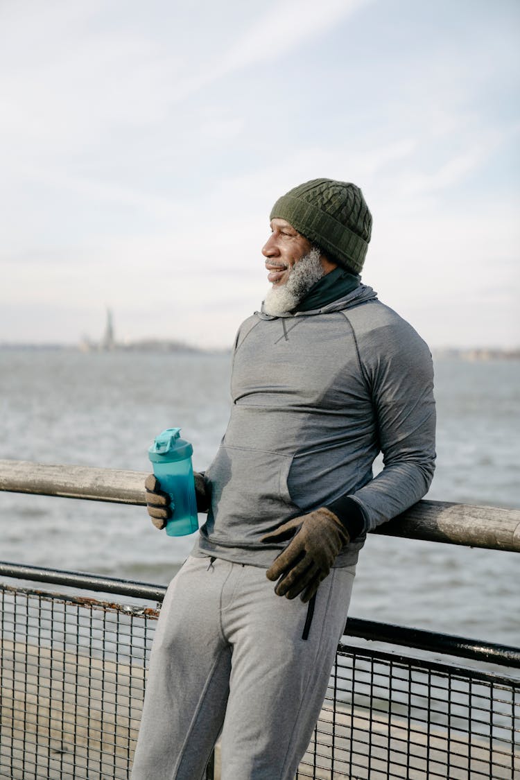 An Elderly Man Holding A Tumbler