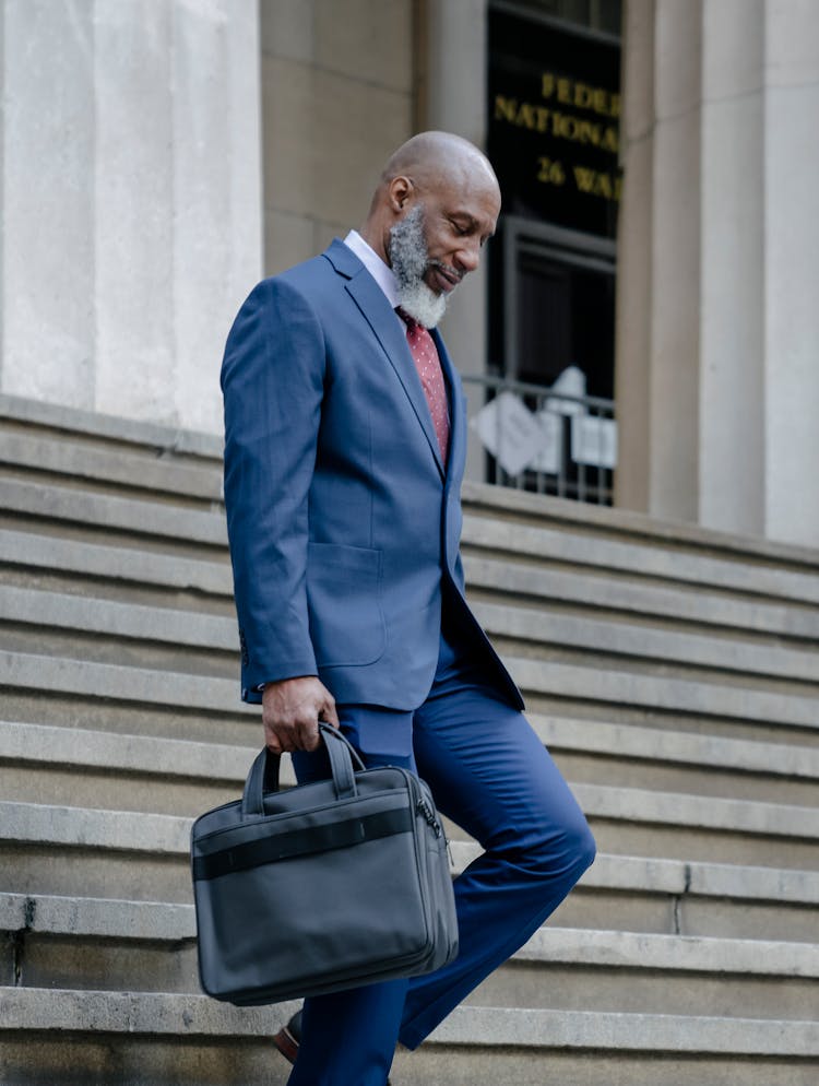 Elegant Man In Beard Walking Down Stairs