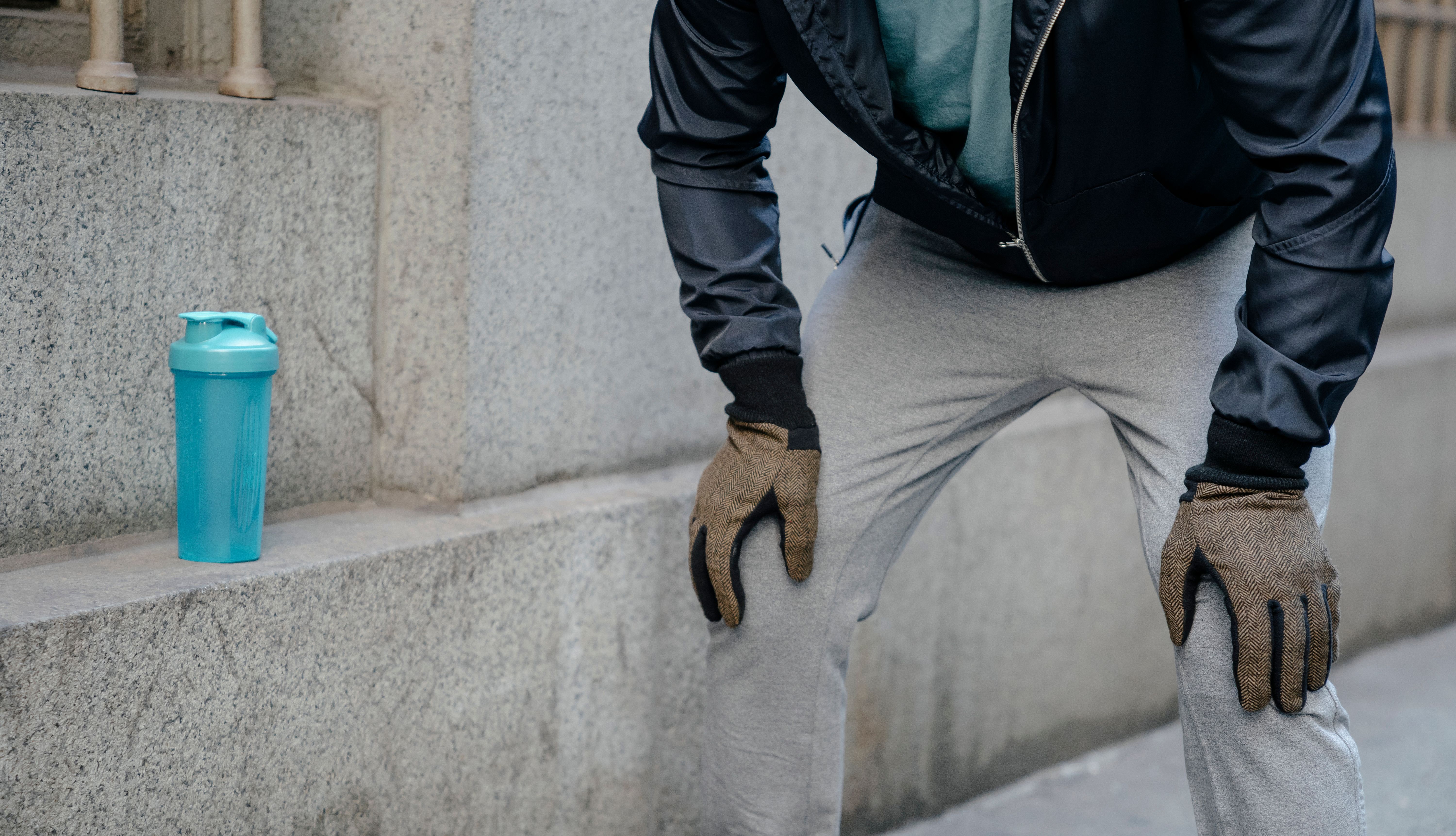 Exhausted runner resting with hands on knees
