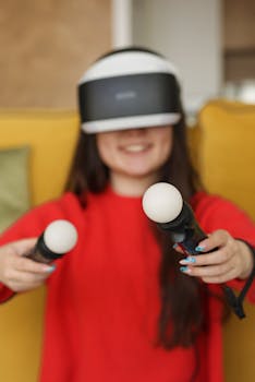Smiling woman using VR headset and controllers for gaming indoors.