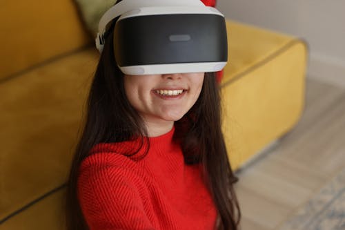Woman Wearing a Sweater Using Virtual Reality Goggles