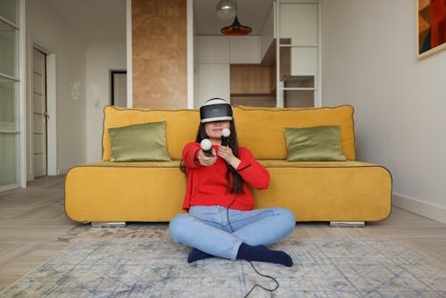 Woman Sitting on the Floor Playing with Virtual Reality Goggles