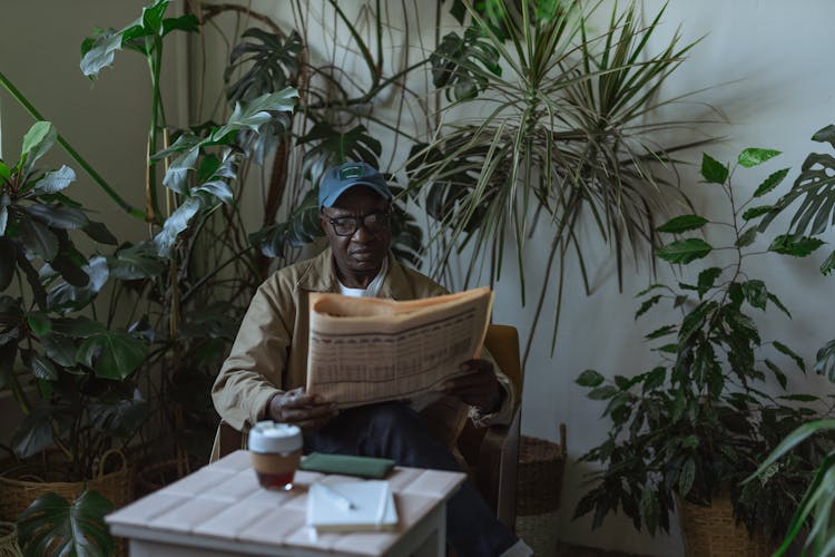 Photo Of An Eldelry Man Reading Newspaper