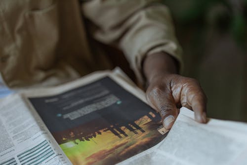 Free Close-Up Photo of Person Holding News Paper Stock Photo