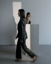 Woman in Black Leather Jacket and Pants Wearing High Heels