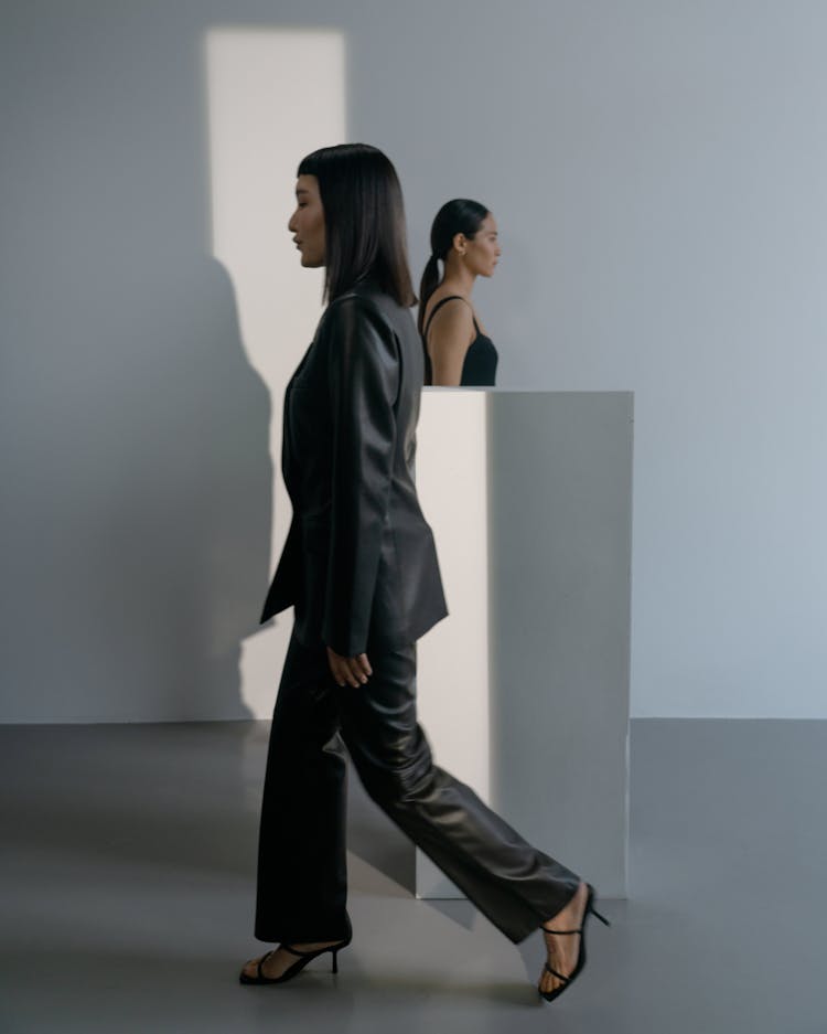 Woman In Black Leather Jacket And Pants Wearing High Heels