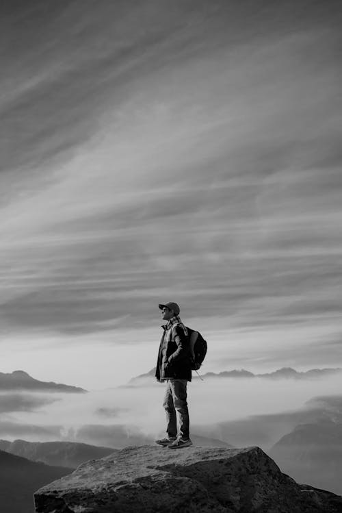 Free A Man Standing on Rock Stock Photo