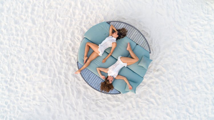 Two Women Relaxing On Deckchair