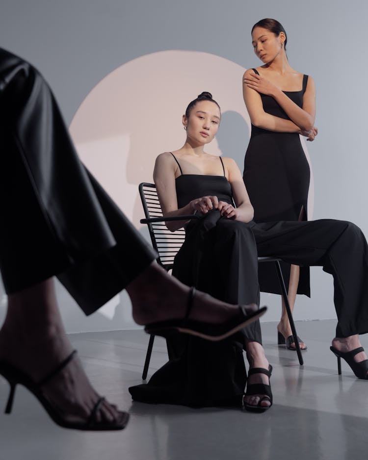 Woman In Black Dress Sitting On Black Chair