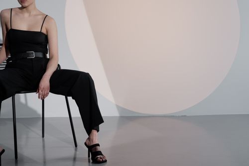 Free Elegant woman in black outfit posing in stylish studio with minimalist design. Stock Photo