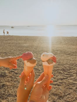Enjoying ice cream cones by the beach on a sunny summer day.