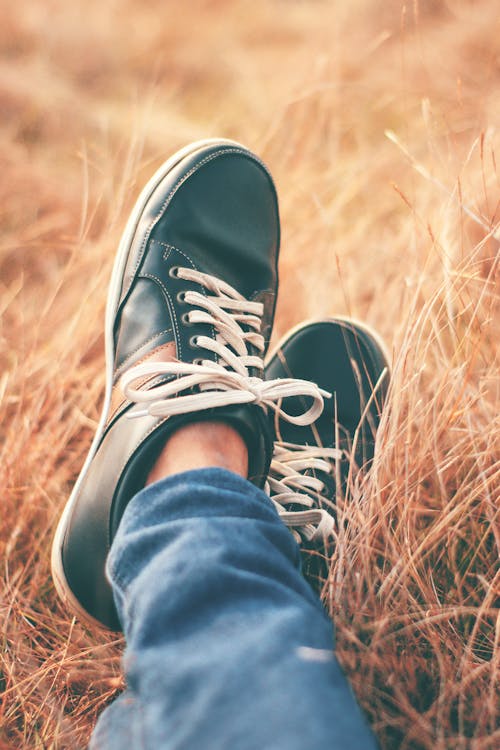 Free A Person Wearing Black and White Sneakers Stock Photo