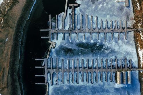Free Aerial view of a frozen marina with docks covered in ice, Lake City, MN. Stock Photo