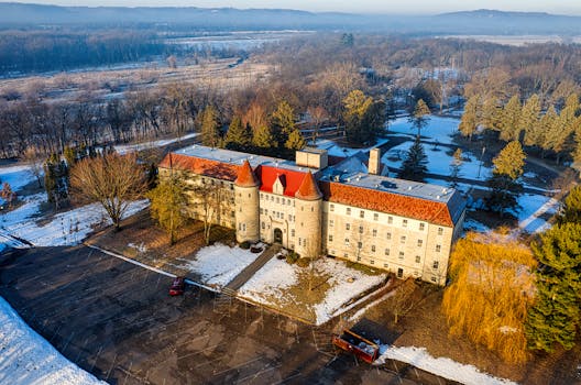 Drone captures the Villa Maria surrounded by snow in Minnesota's winter landscape.