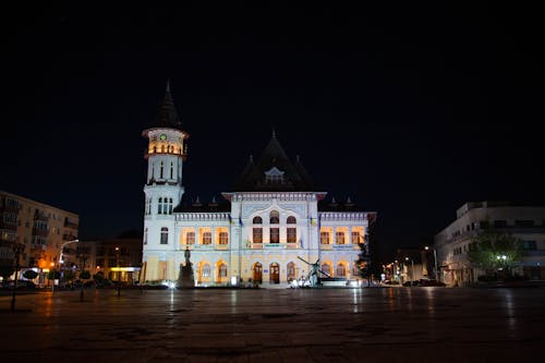 White and Brown Concrete Building during Night Time