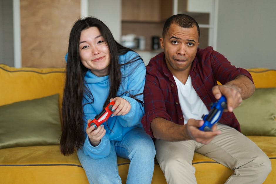 A couple sitting together indoors and playing video games, enjoying leisure time.