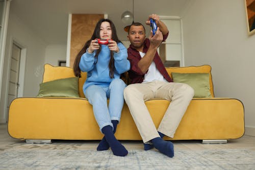 Low-Angle Shot of a Couple Playing Video Game Together at Home
