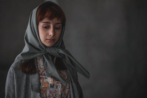 Woman in Gray Headscarf Standing in the Studio