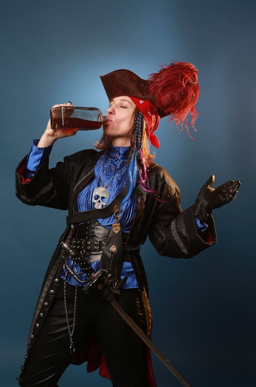 Woman in Pirate Clothes Drinking Rum from Bottle