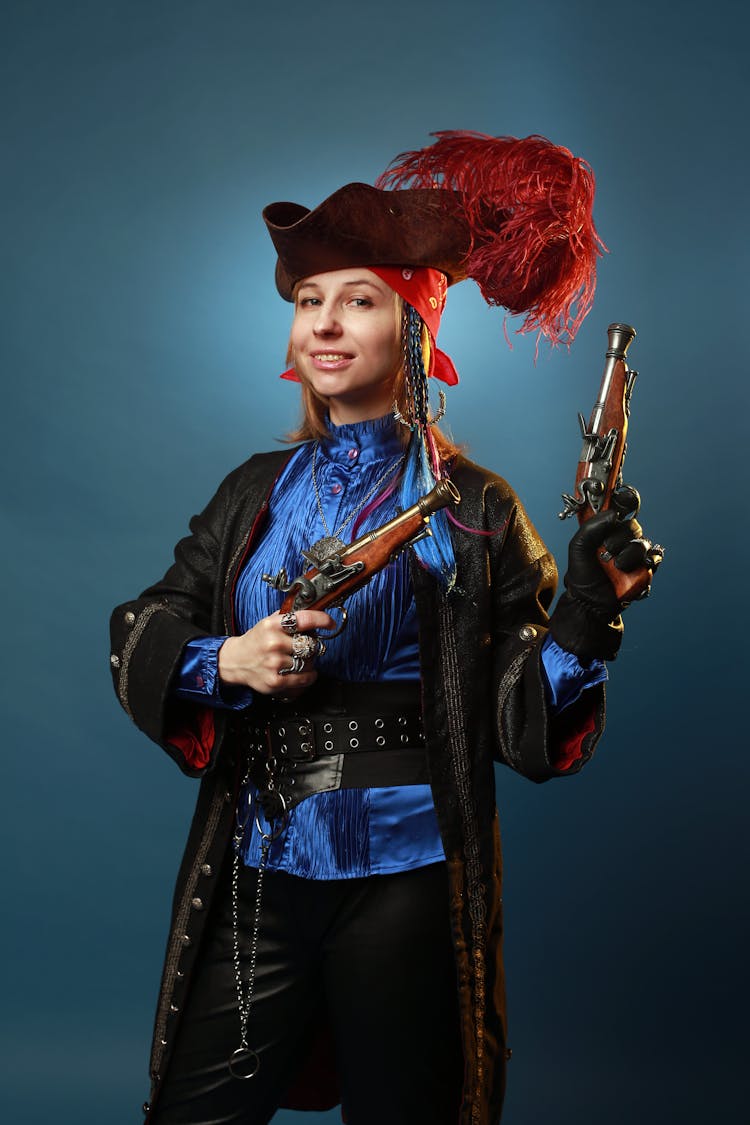 Woman In Musketeer Costume With Pistols