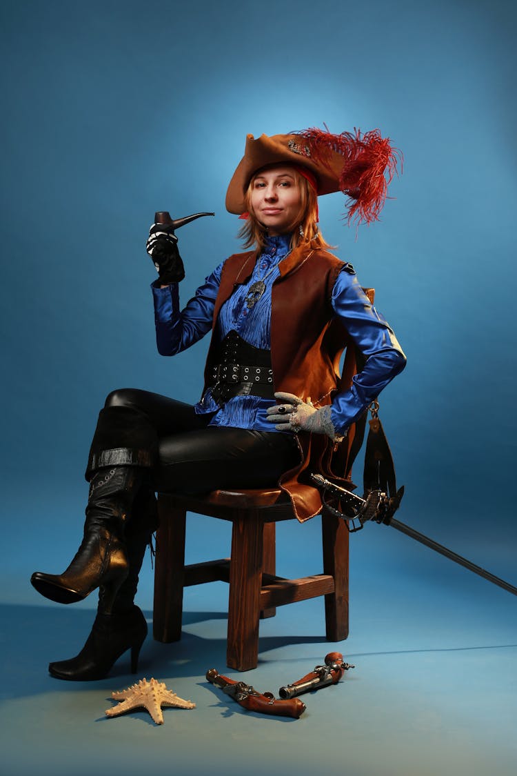 Woman In Pirate Costume Sitting On Chair