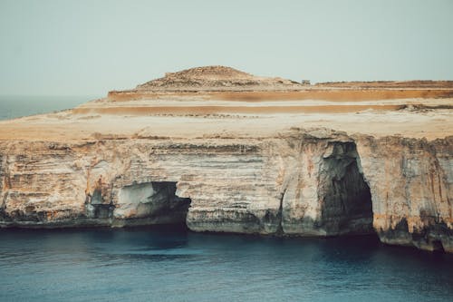 Textured Rock Formation and Sea