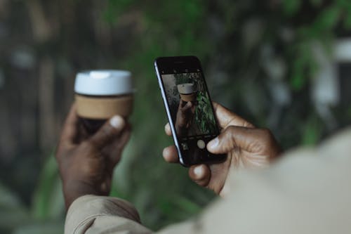 Photo of Person Taking Pictures Using Black Mobile Phone