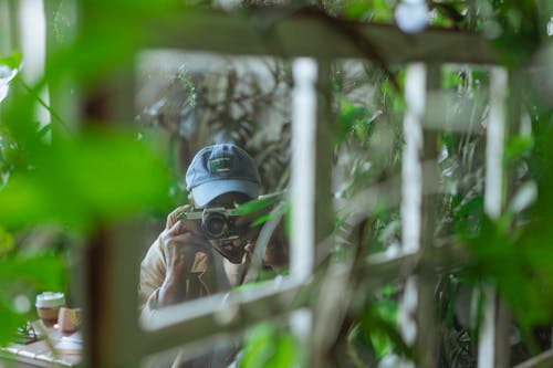 Free  Selective Focus Photo of Elderly Man Using Camera Stock Photo