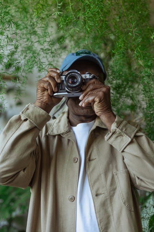 Photo of Man Using SIlver Vintage Camera