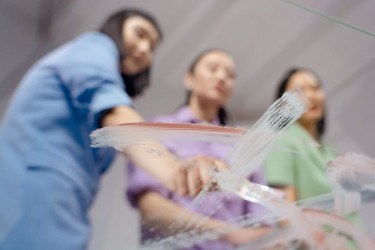 Women Painting The Glass Table