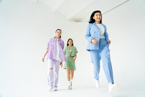 Low Angle Shot of Young Women in Trendy Pastel Outfits