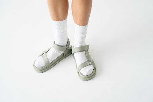 Free A Person Wearing White Socks and Sandals Stock Photo