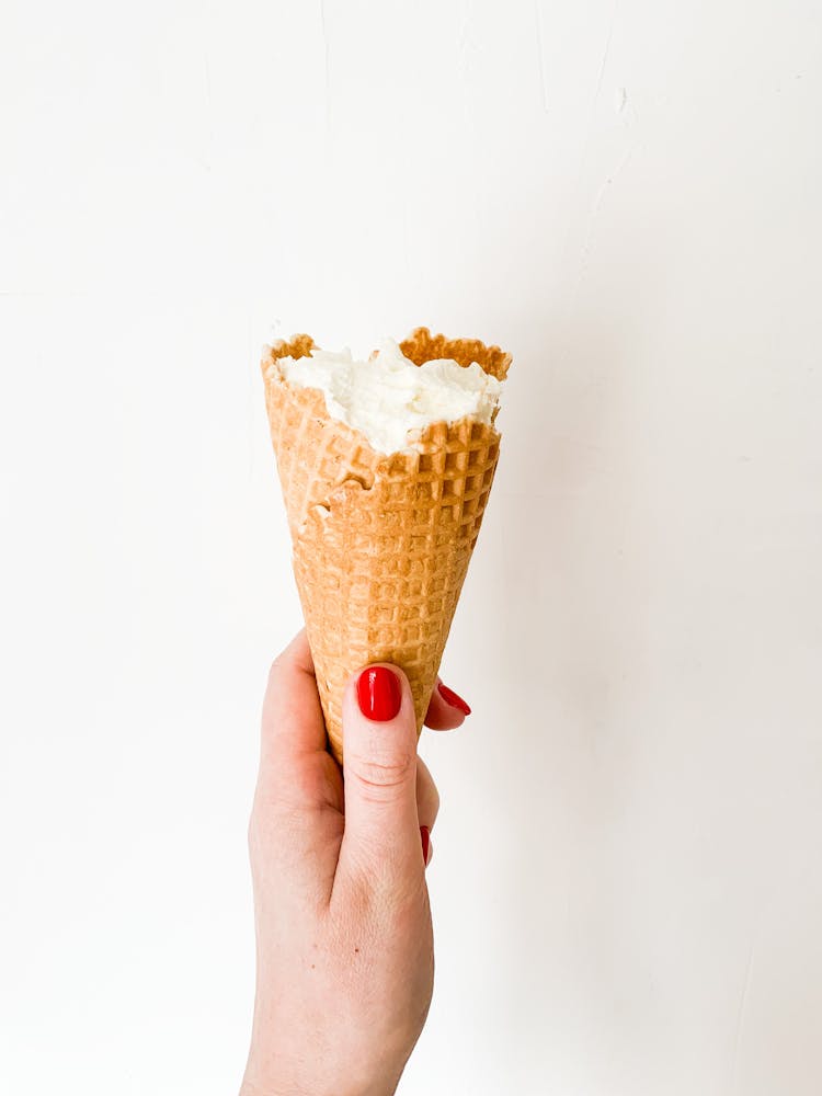 A Person Holding An Ice Cream Cone