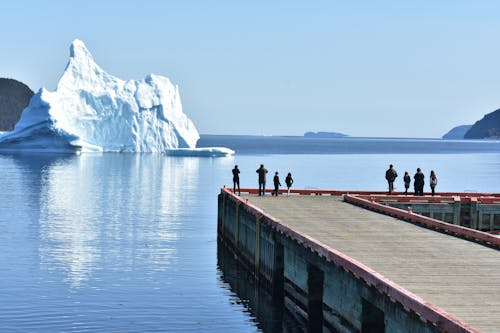 Iceberg Near a Dock with People