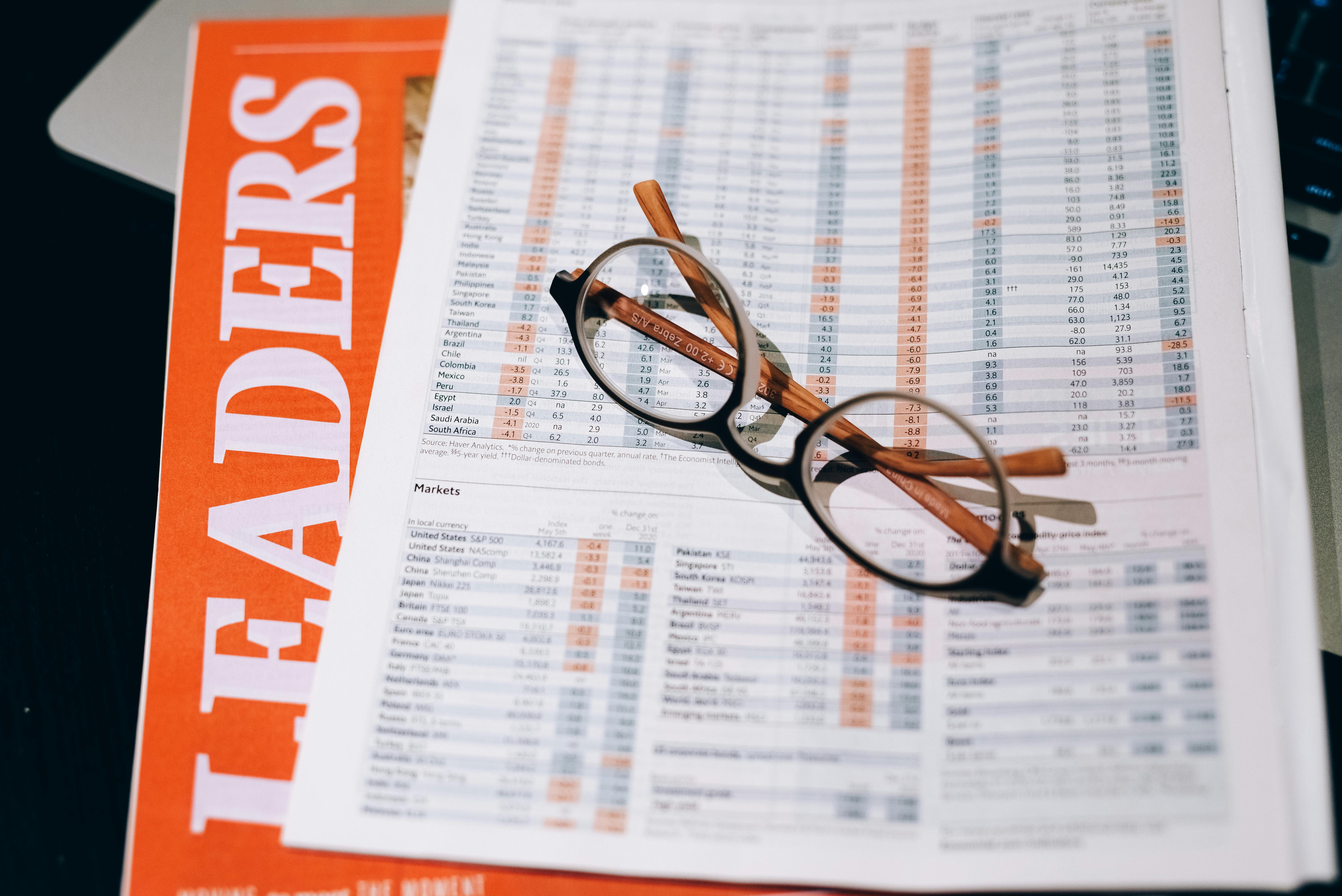 black framed eyeglasses on white and orange paper